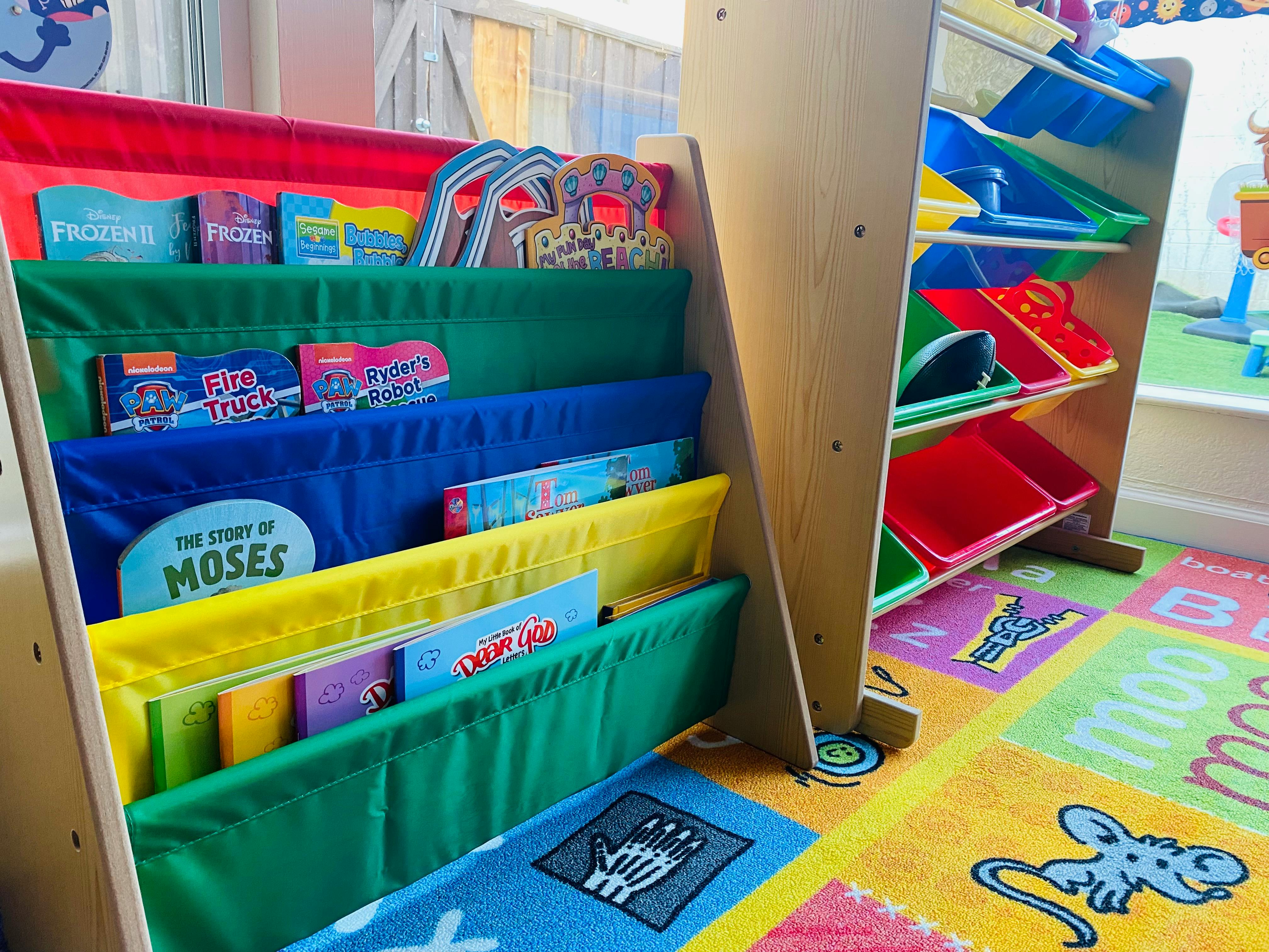 Children's book display with colorful fabric pockets and storage bins