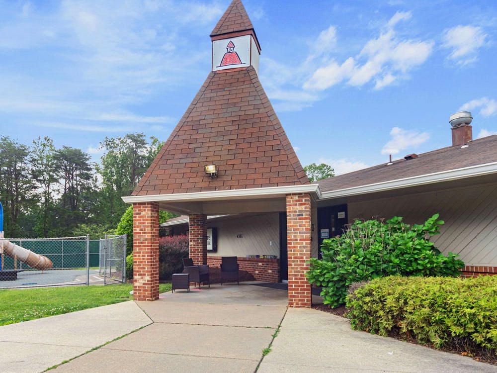 Entrance to a building with a playground to the left