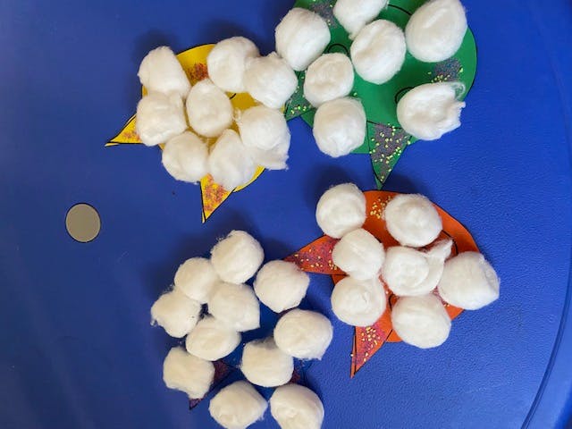 Crafts made from cotton balls on paper cutouts