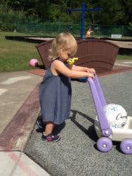 Child pushing a toy stroller