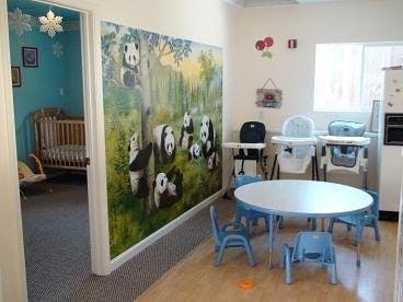 Childcare room with panda mural and small table with chairs