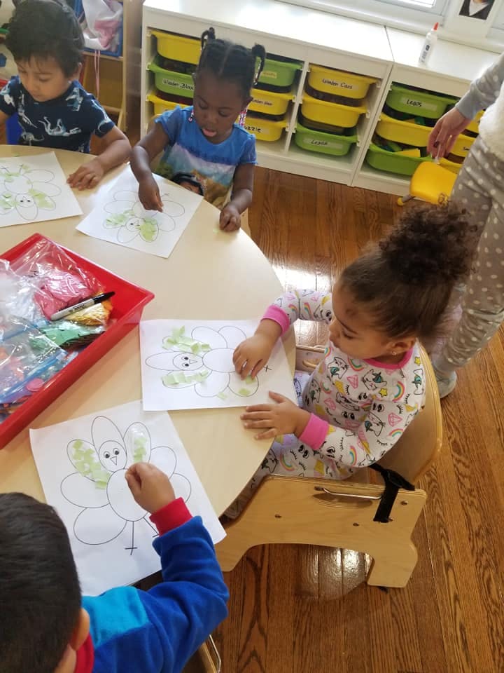 Children coloring at a table in a classroom