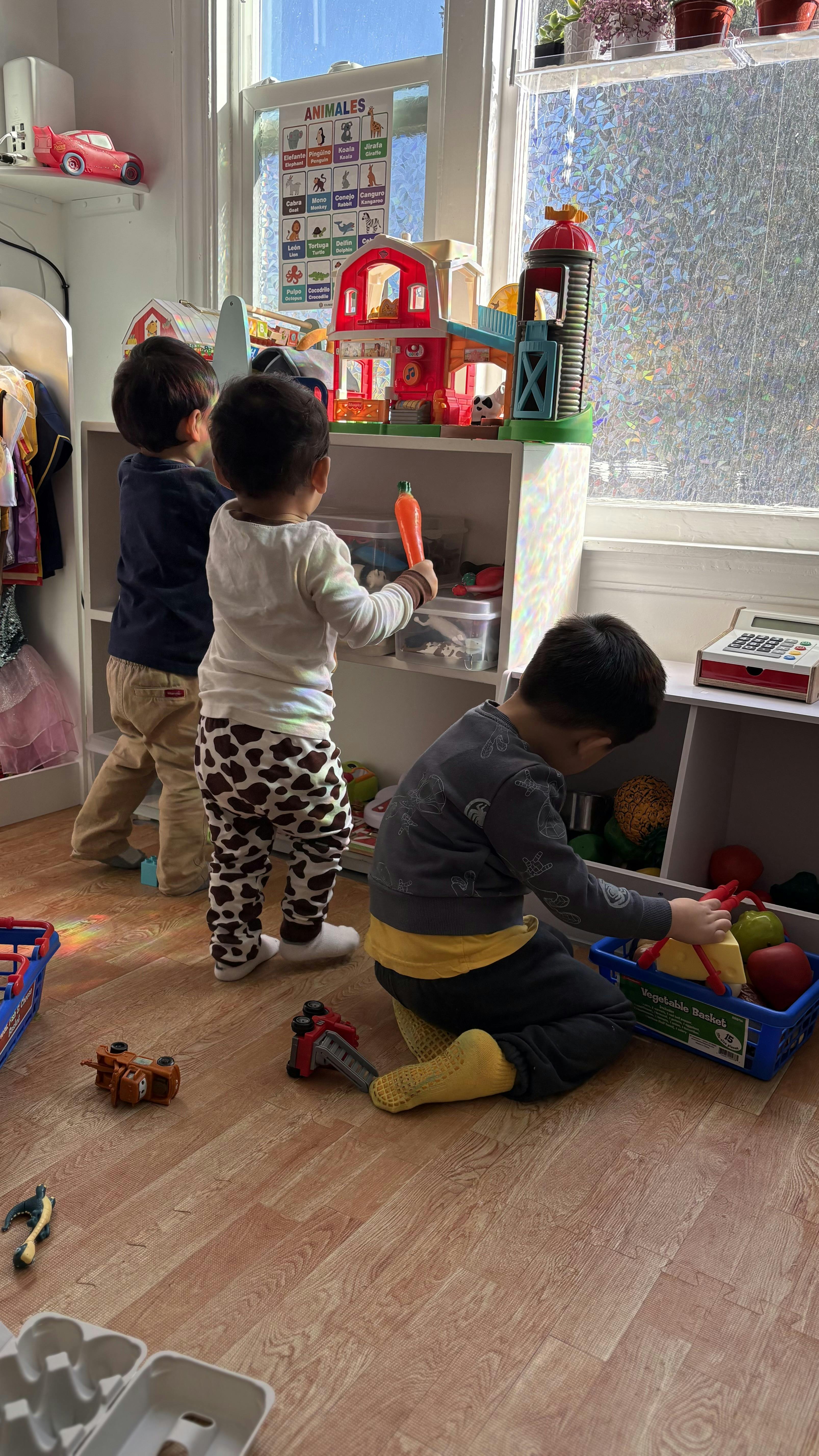 Three children playing with toys in a room