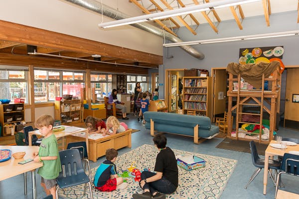 People and children in a classroom
