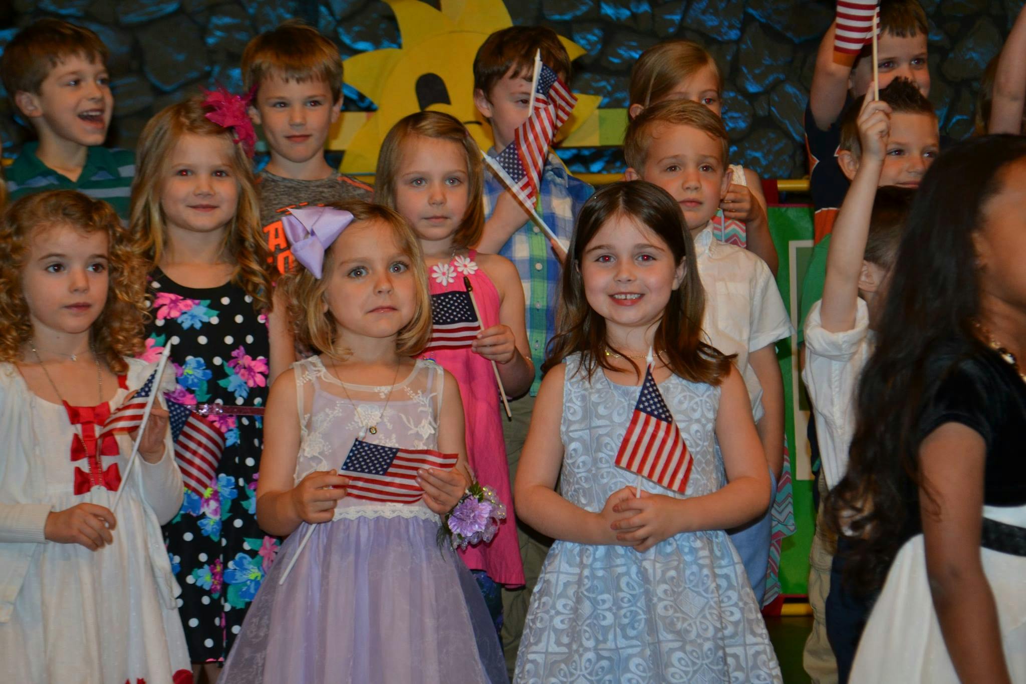 Group of children holding small American flags