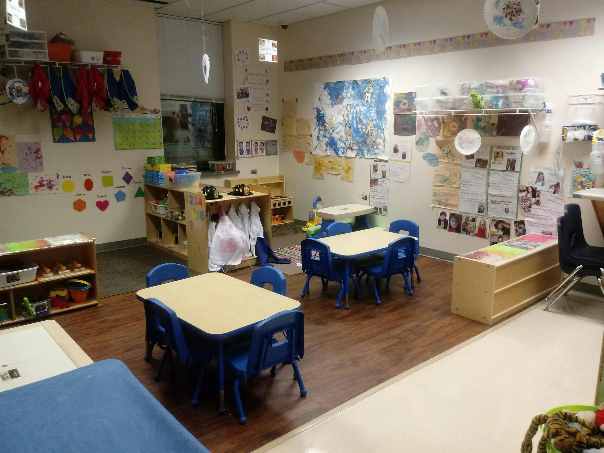 Empty classroom with small tables and chairs
