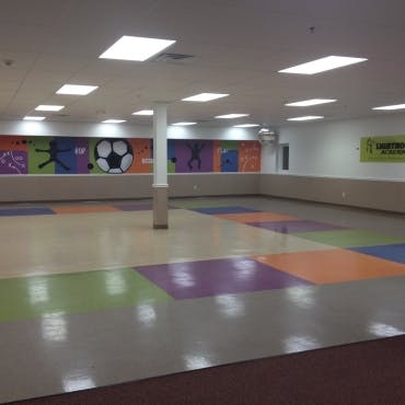 Empty room with colorful floor tiles and wall murals