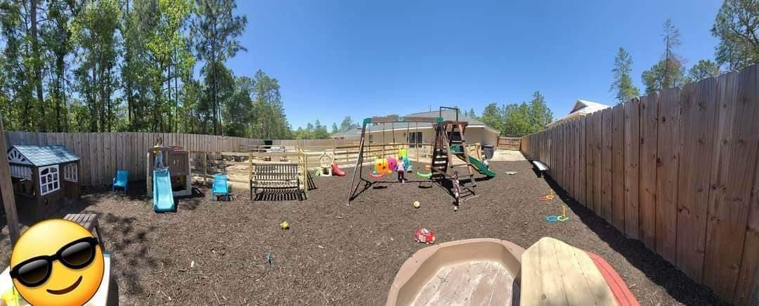 Outdoor playground with swings, slides, and play structures
