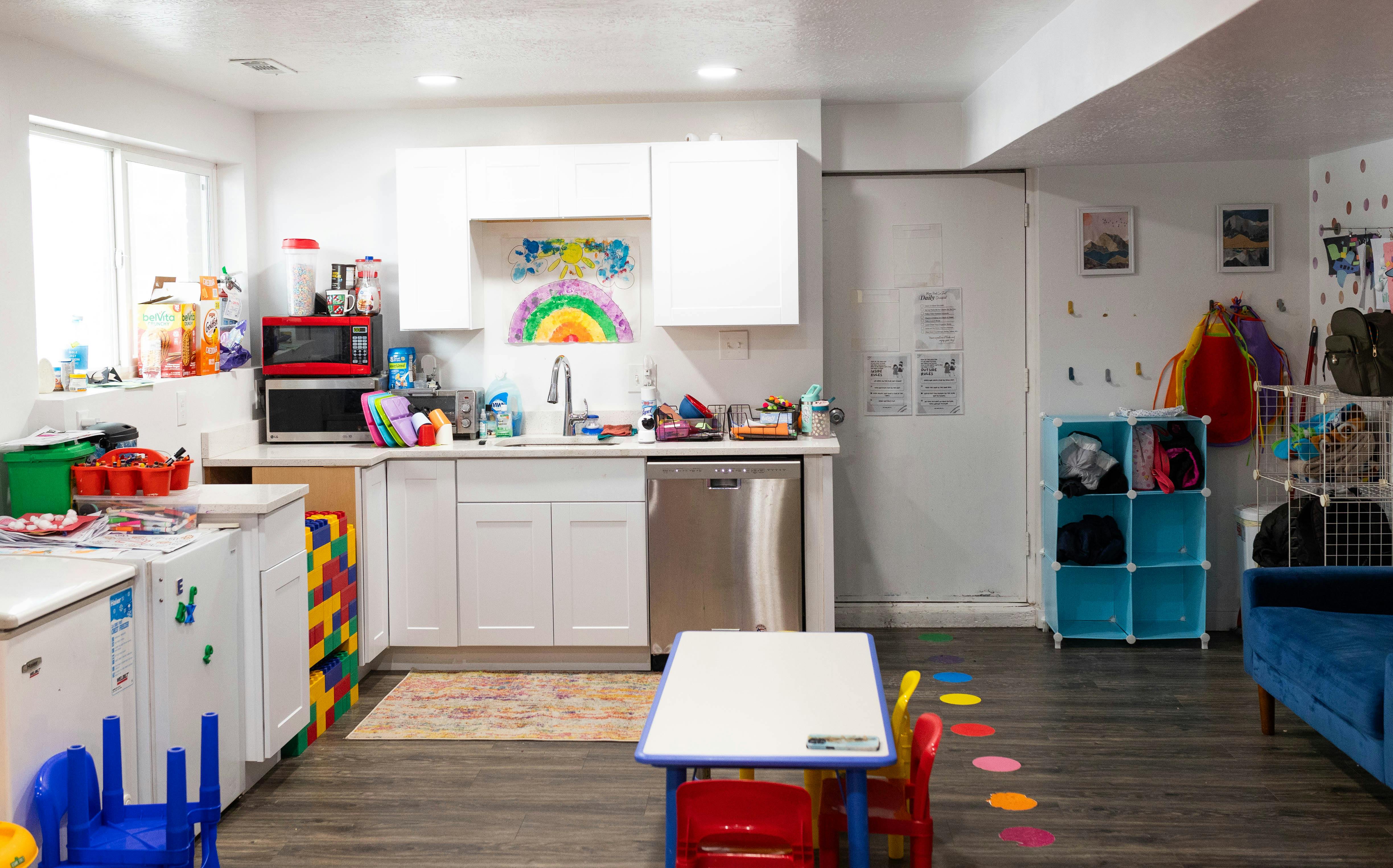 Kitchen area with white cabinets and a small table with chairs