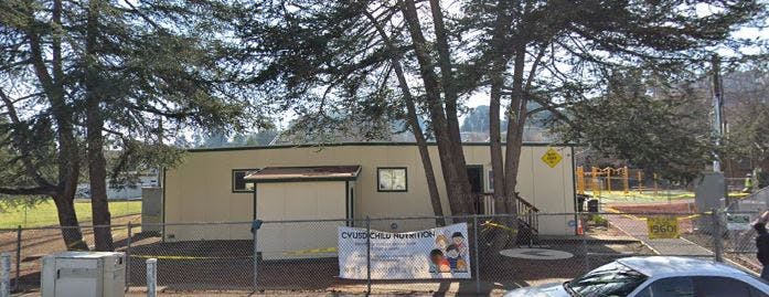 Portable building with trees in front