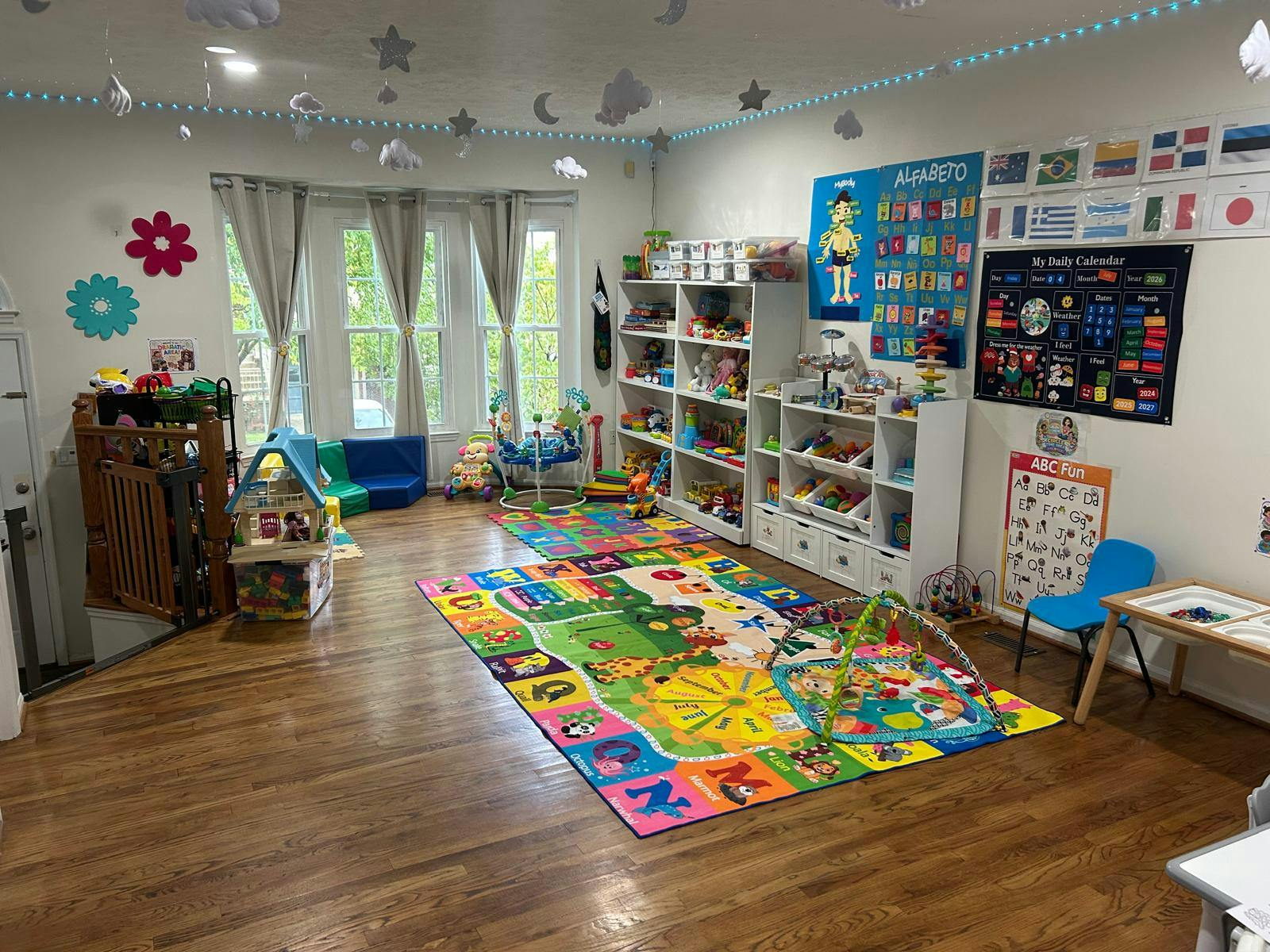 Brightly decorated playroom with colorful floor mats and shelving for toys
