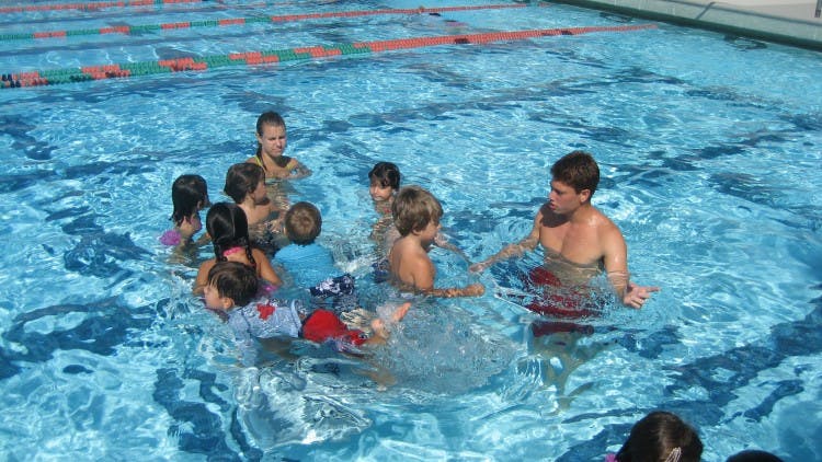 Adult and children in a swimming pool