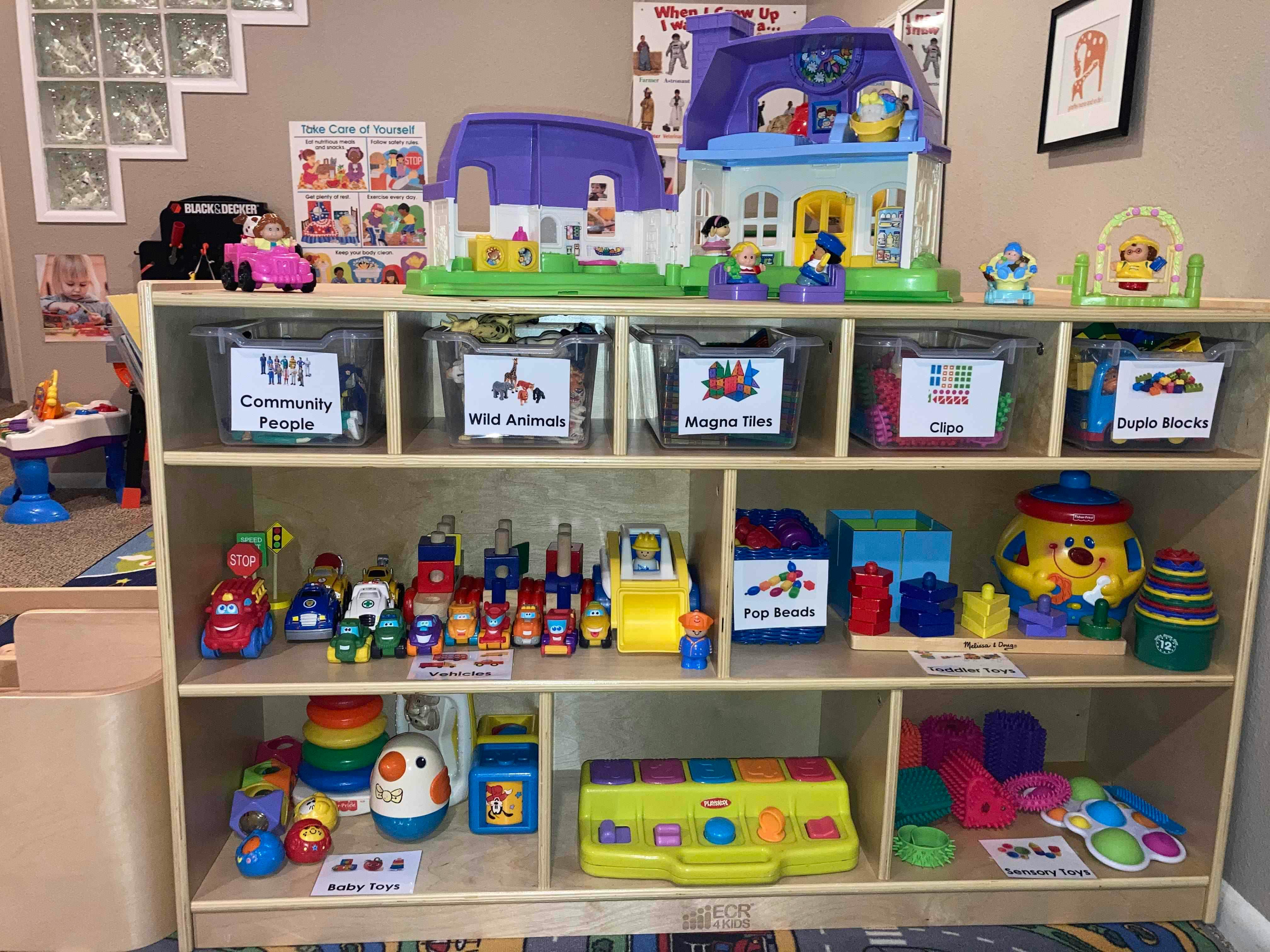 Shelves filled with various toys and play items in a classroom setting