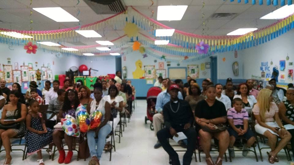 People sitting in rows of chairs in a decorated room