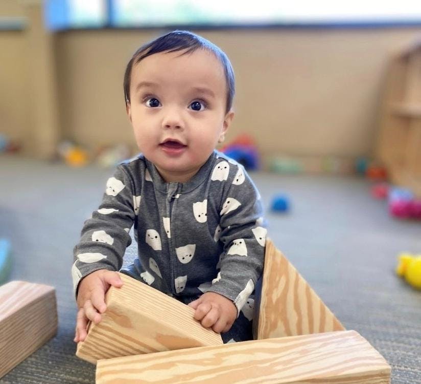 Child playing with wooden blocks