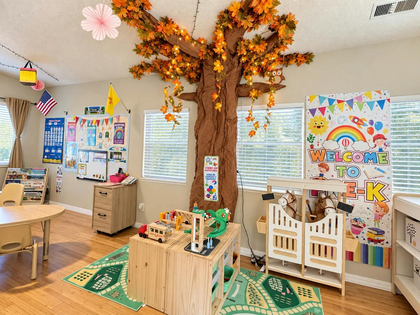 Classroom interior featuring a decorative tree and a welcome to pre-k sign