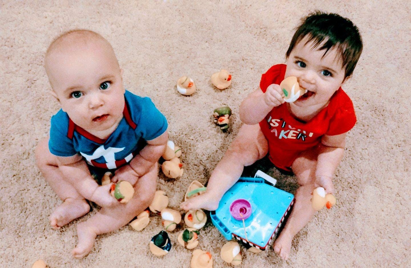 Two children playing with toys on the floor