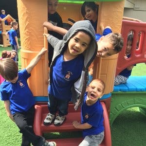 Children playing on a colorful outdoor play structure