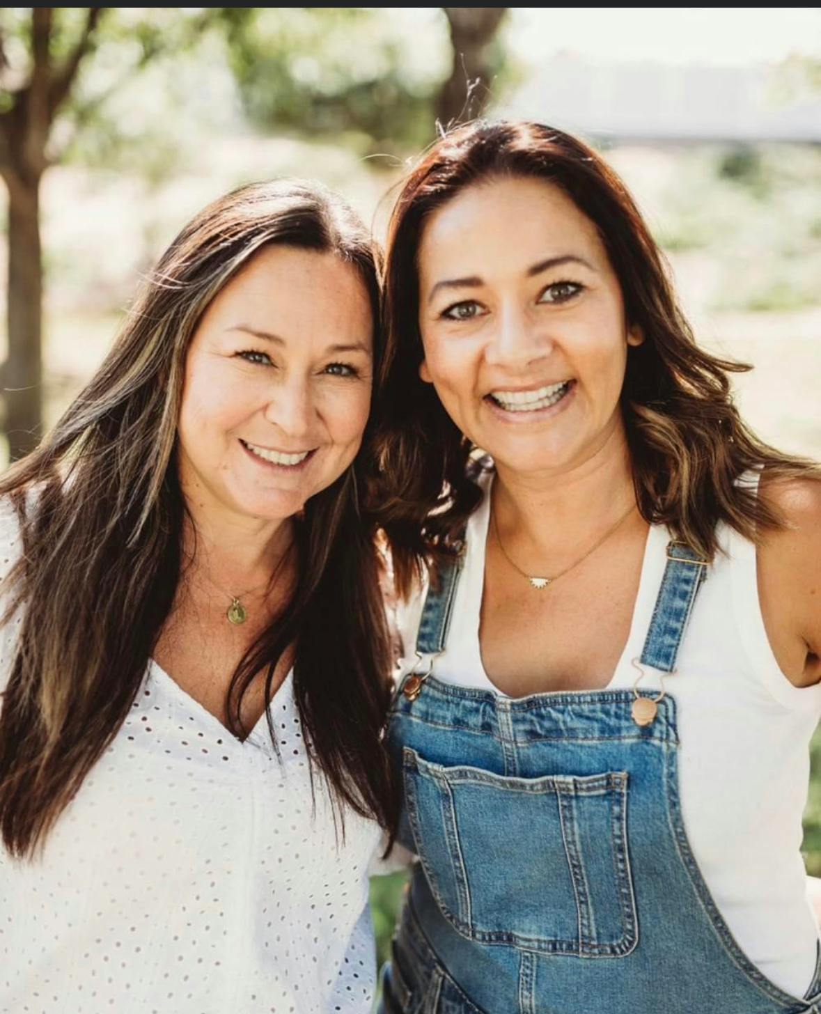 Two people smiling at the camera