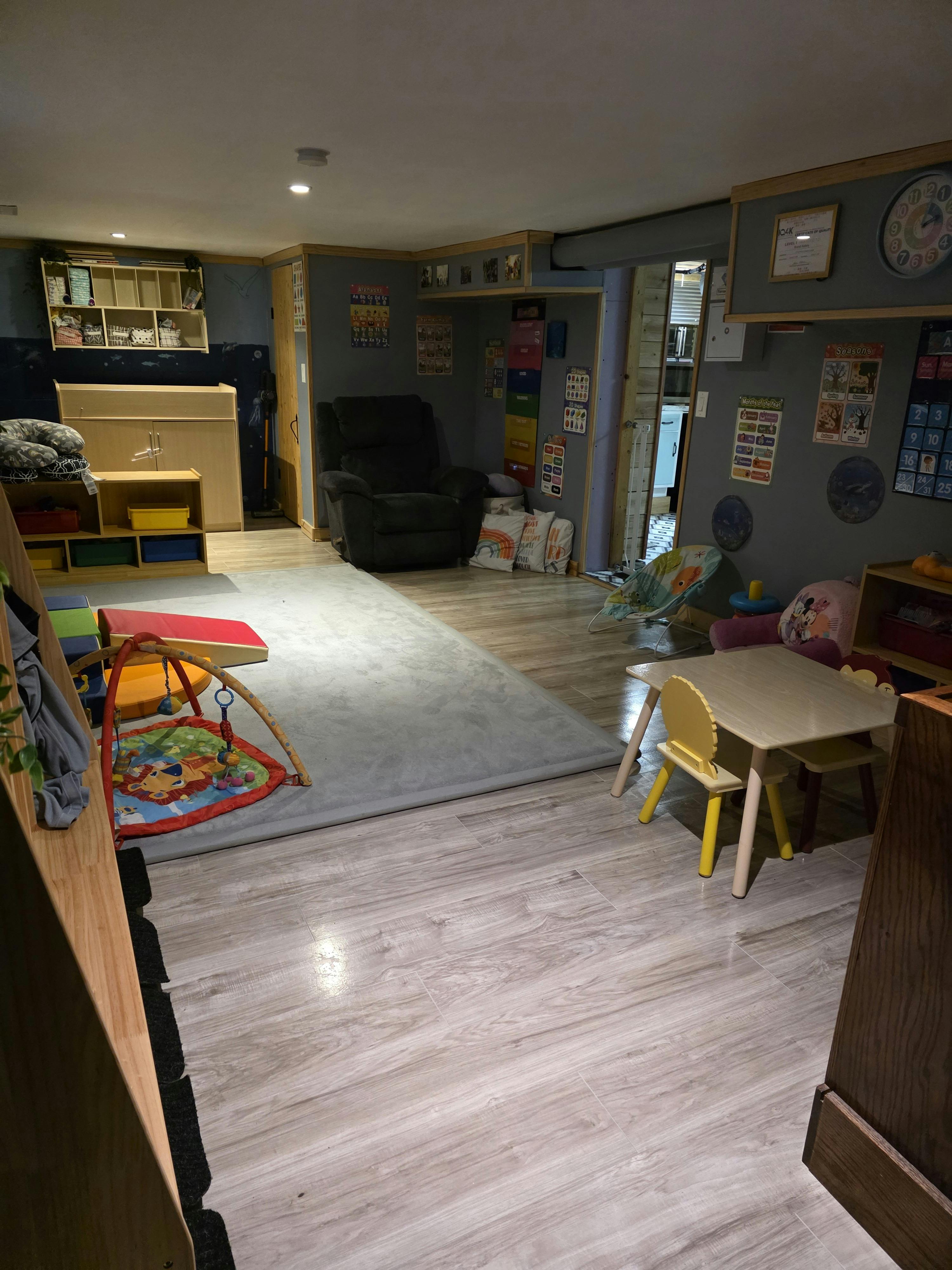 Playroom with children's furniture toys and an area rug