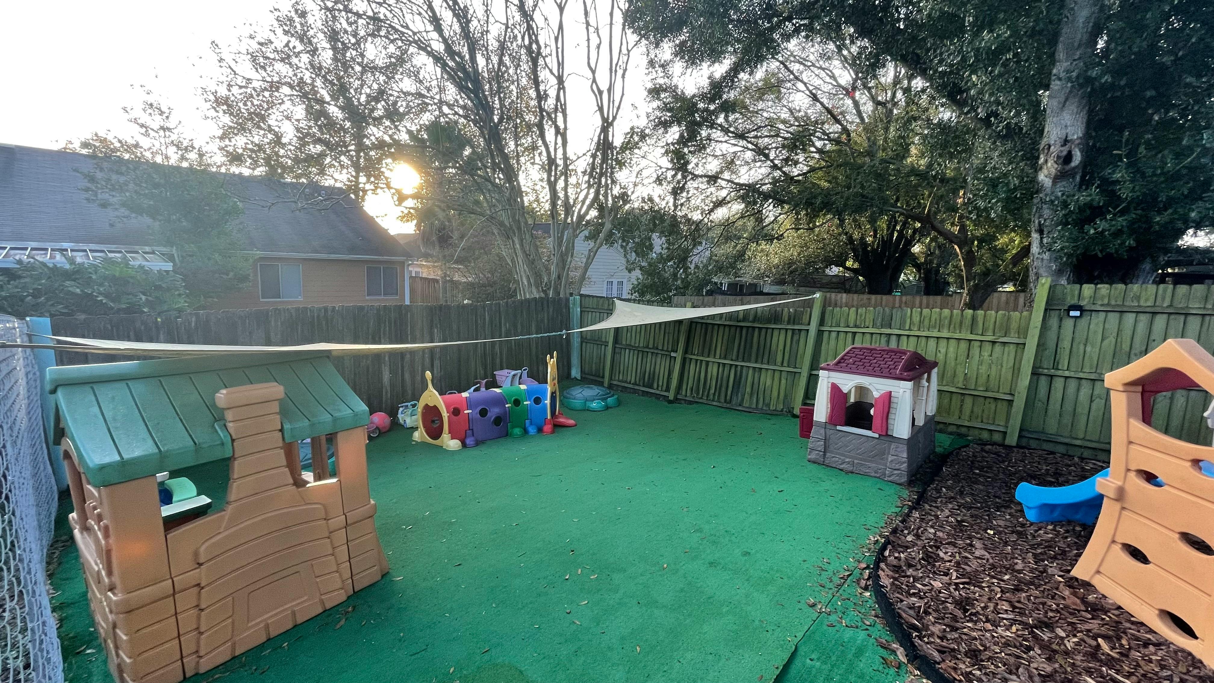 Outdoor play area with artificial turf and various play structures