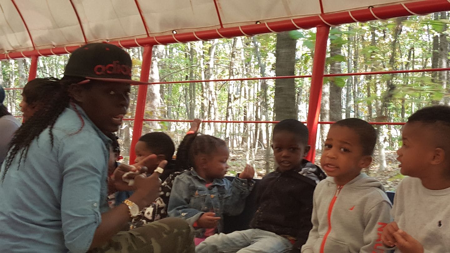 Person with children in an open-air vehicle