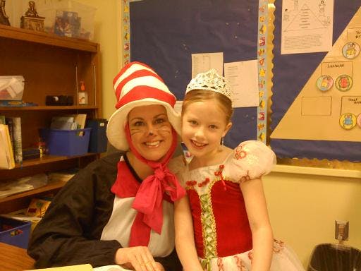 Person in striped hat and child in crown and crown