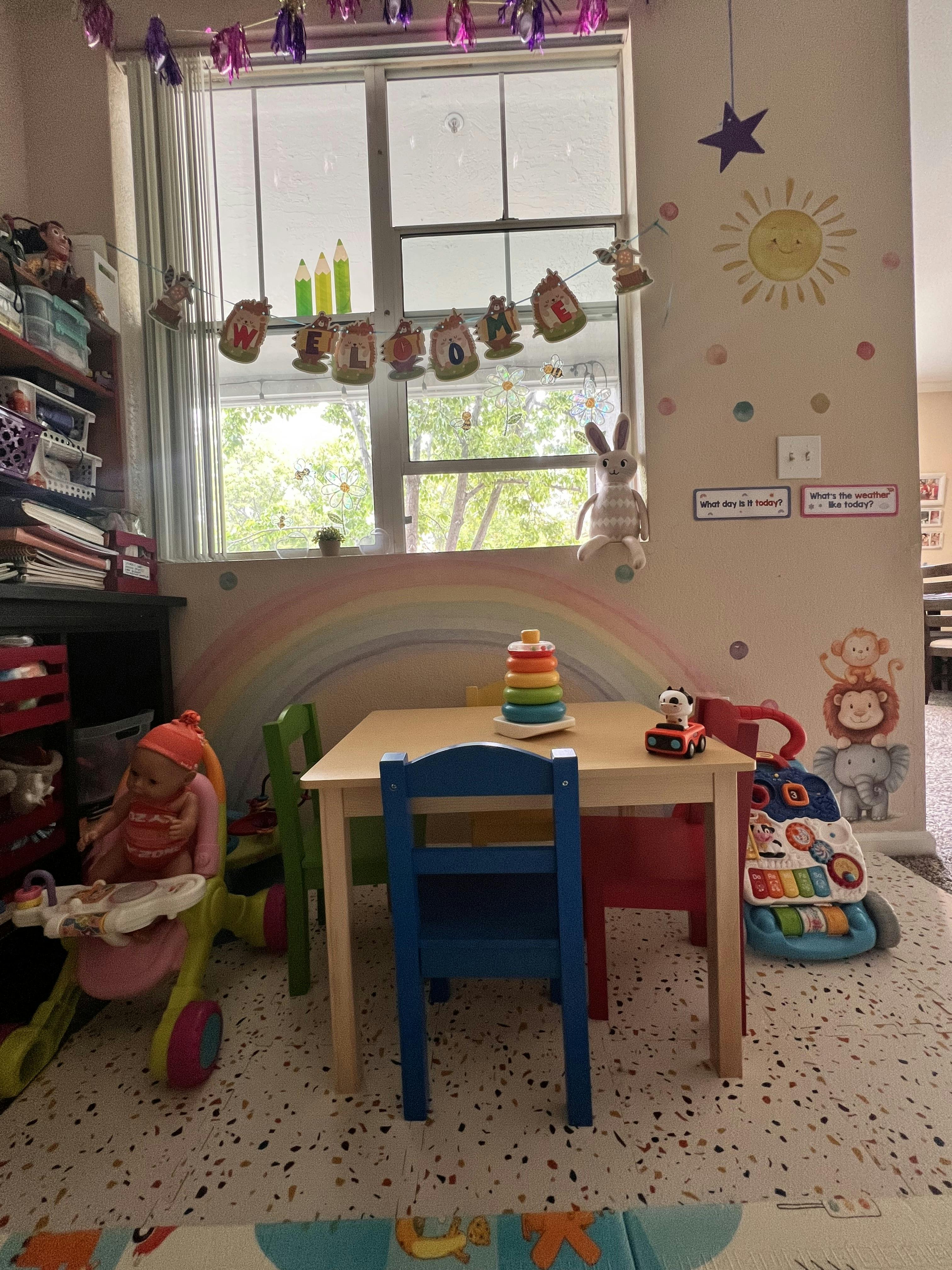 Classroom with a table and chairs, toys, and decorations