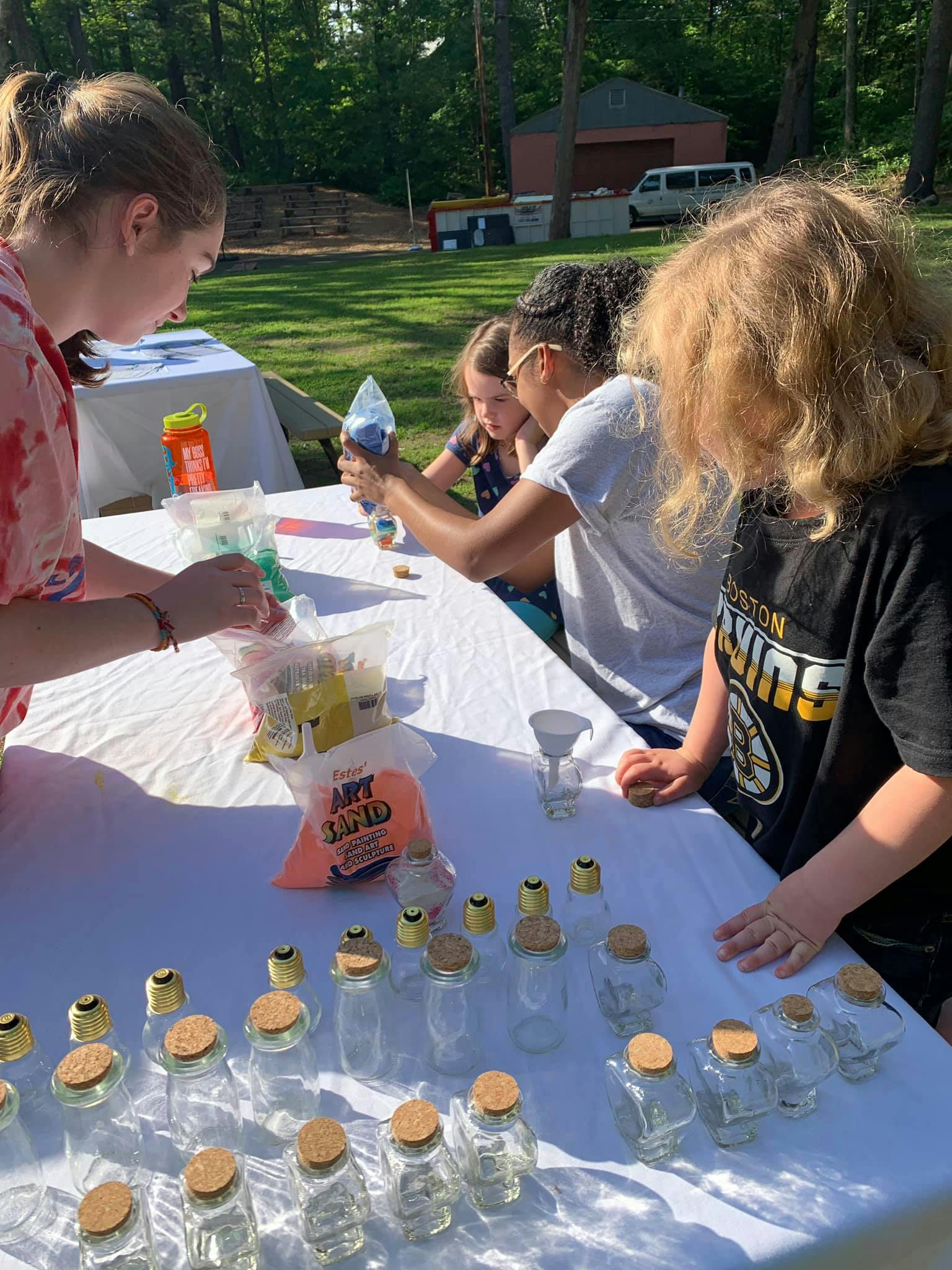 People making crafts at a table outdoors