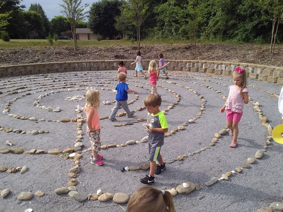 Children walking in a stone labyrinth