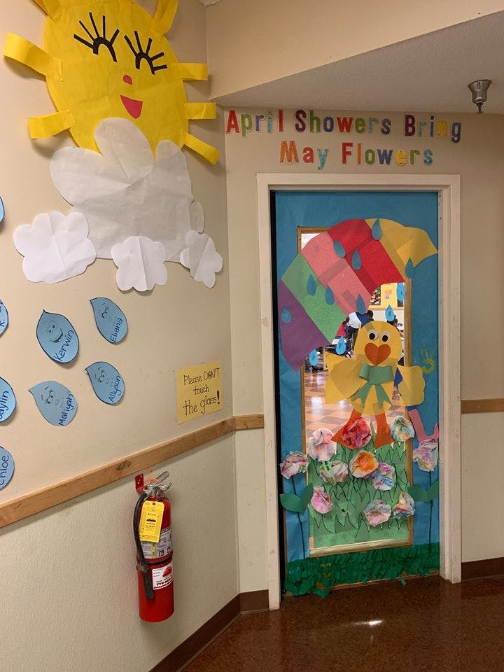 Classroom door and wall decorated with spring-themed cutouts