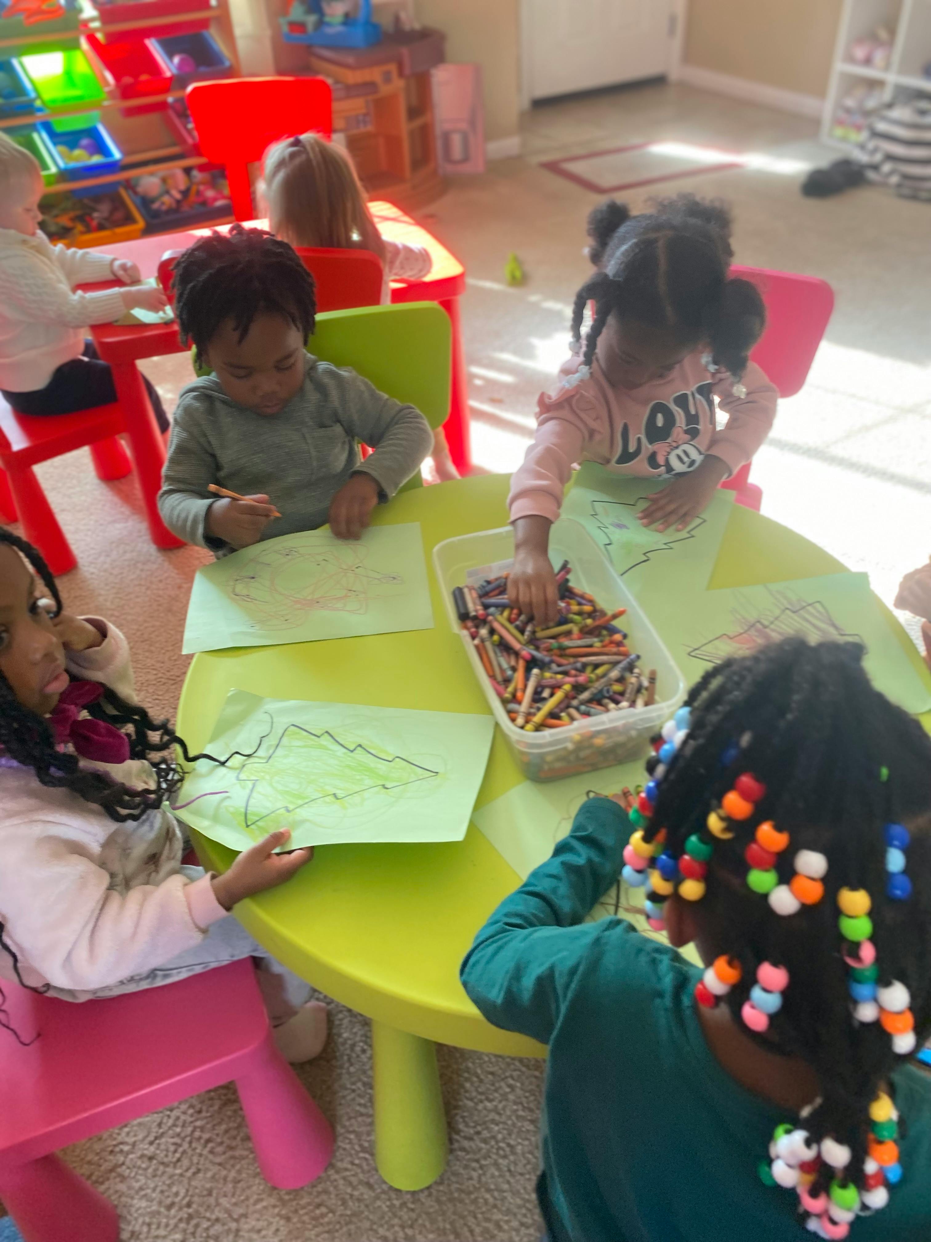 Children drawing at a table in a classroom