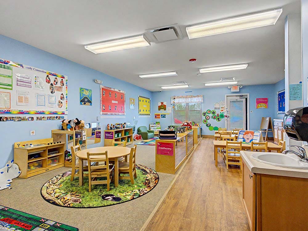 Classroom with tables, chairs, and play areas