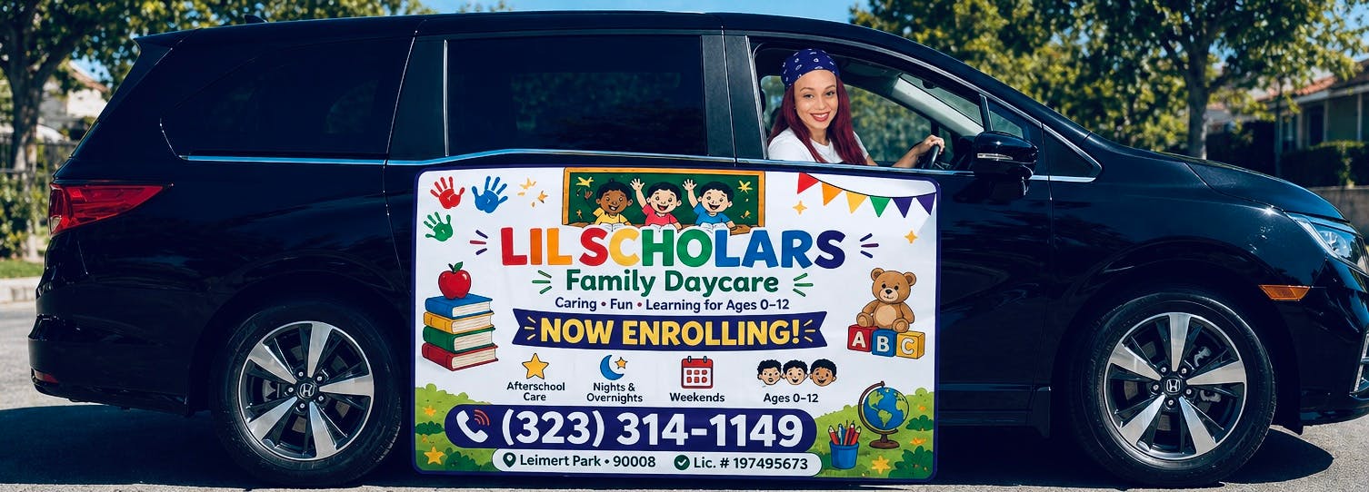 Person in a car with a "Lil Scholars Family Daycare Now Enrolling" sign