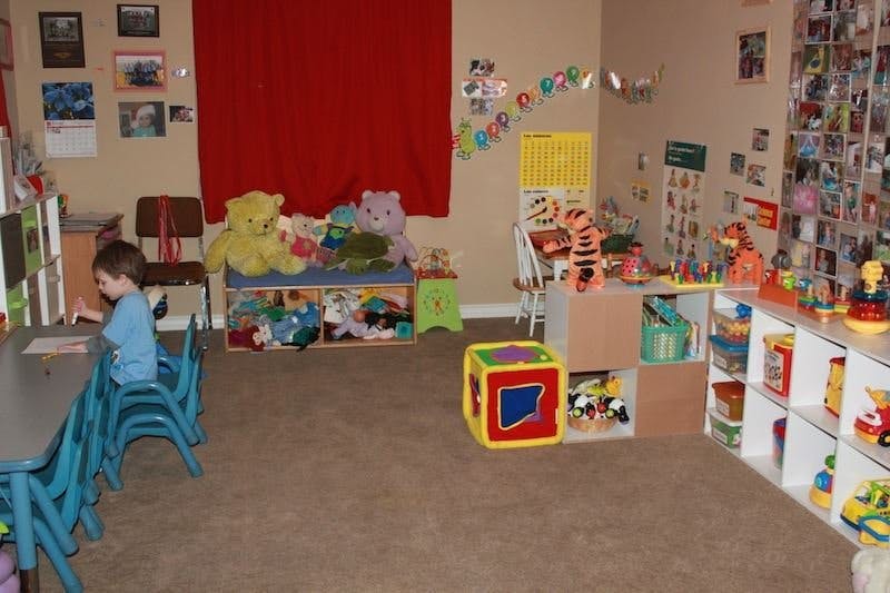 Child sitting at a table in a playroom