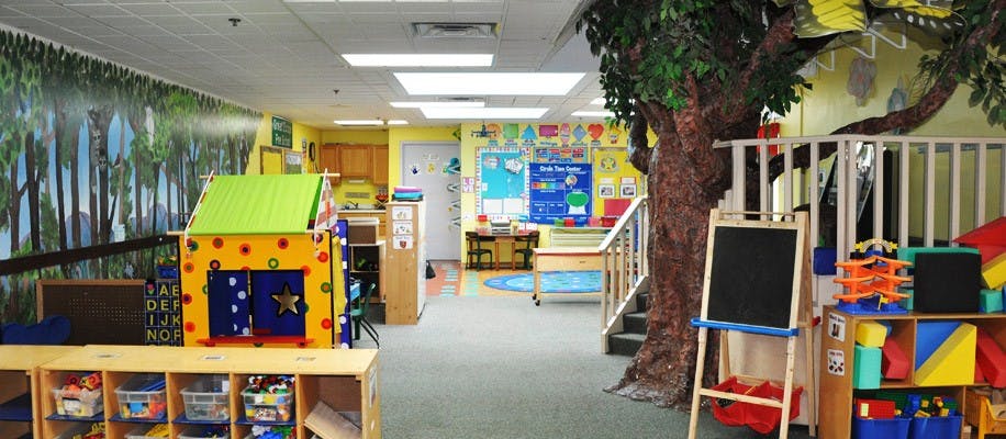 Playroom with a playhouse, tree, and various toys