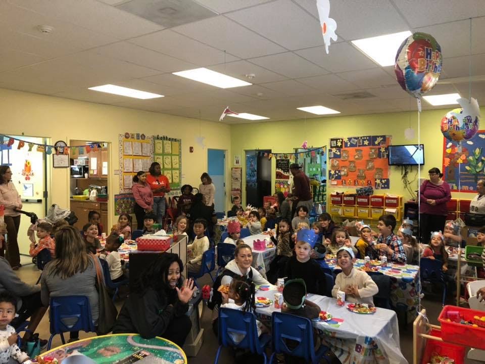 People and children gathered in a classroom