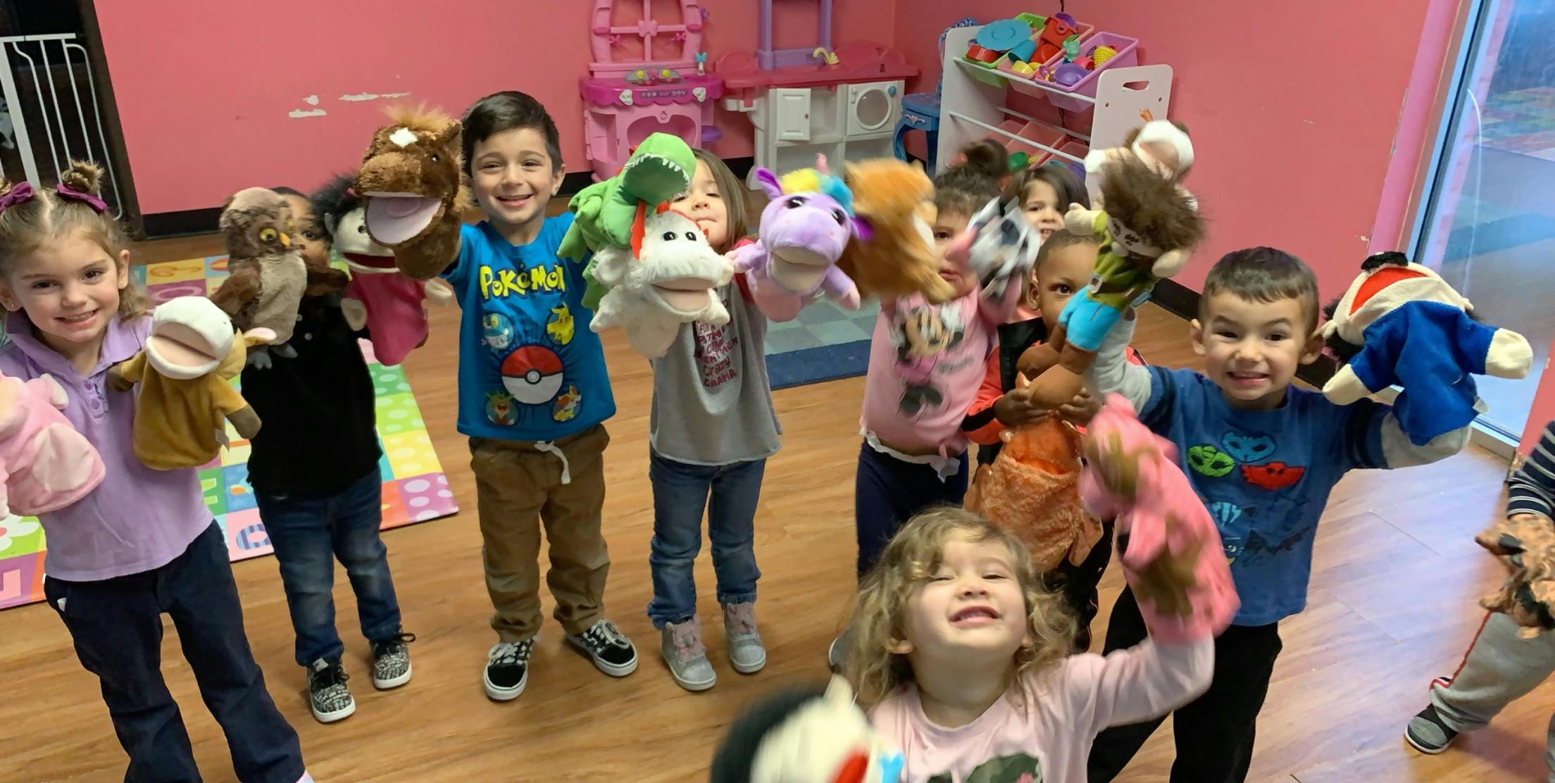 Children holding up puppets