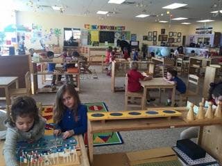 Children in a classroom working at tables