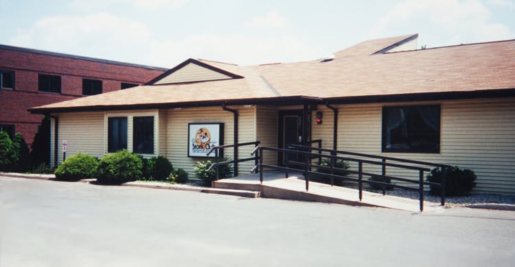 Building exterior with a wheelchair ramp leading to the entrance