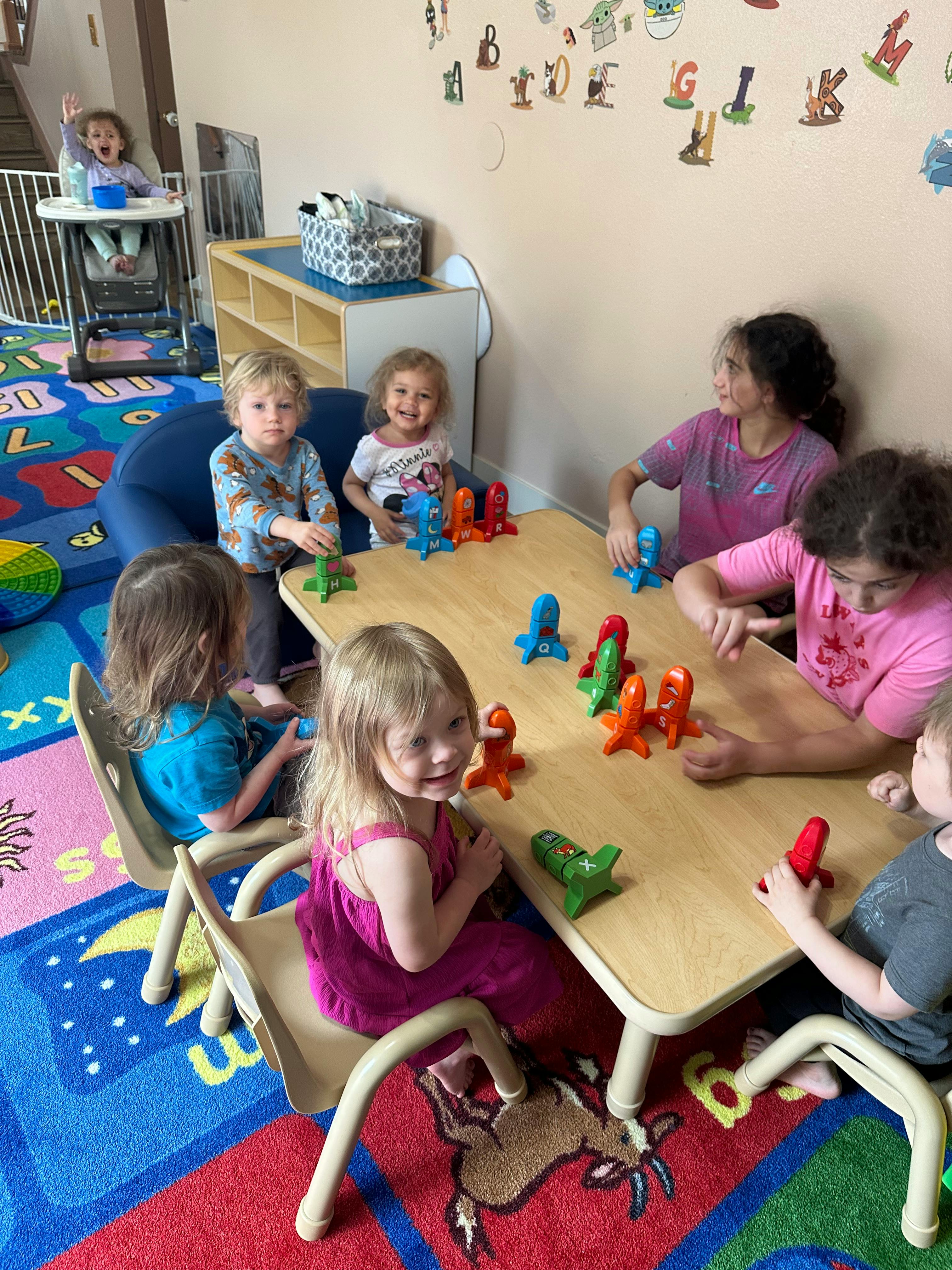 Children playing with toys at a table