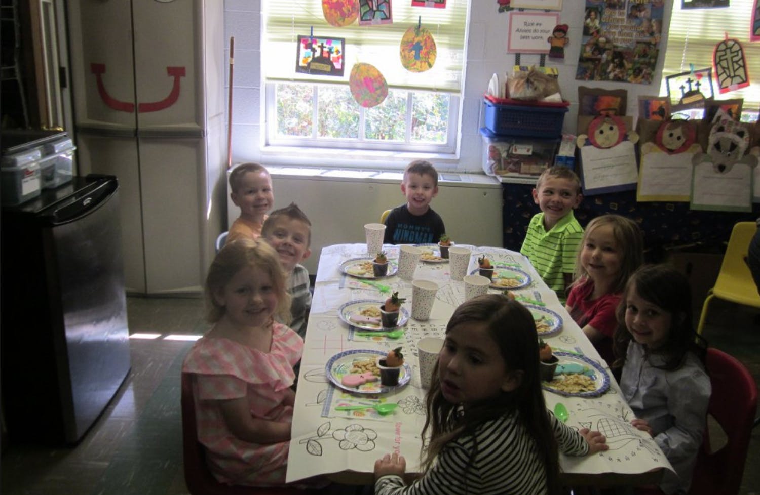 Children sitting around a table in a classroom