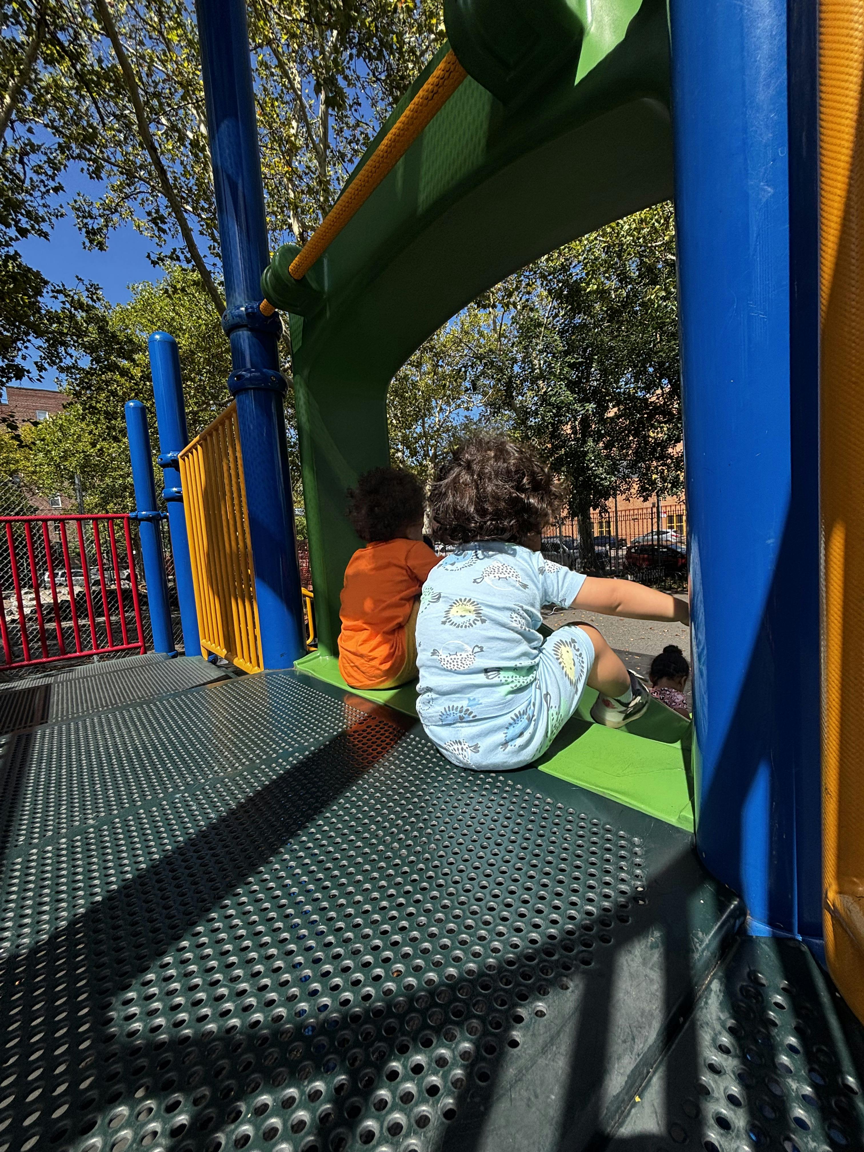 Children sitting on a playground platform