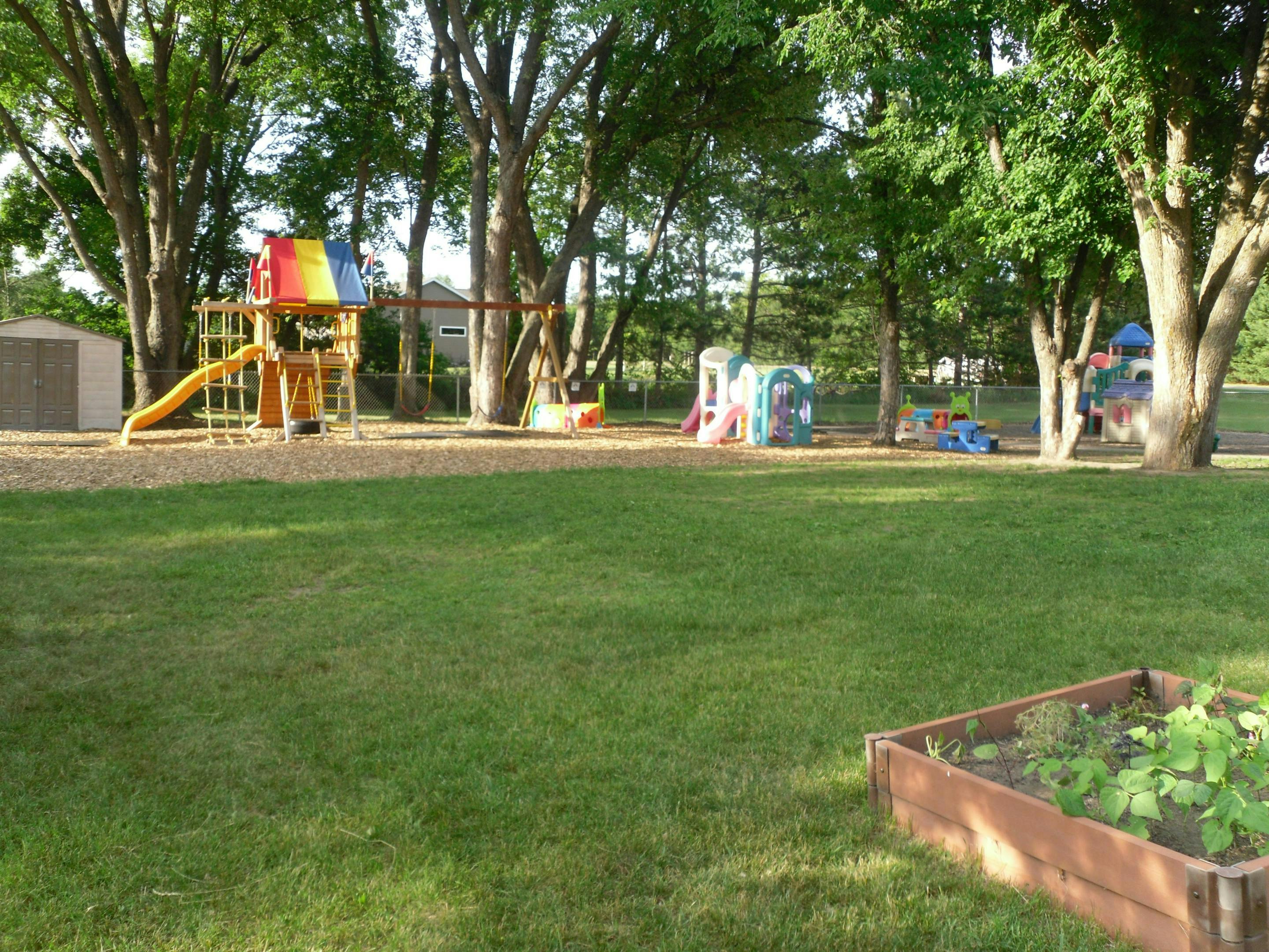 Playground with colorful play structure, swings, and slides