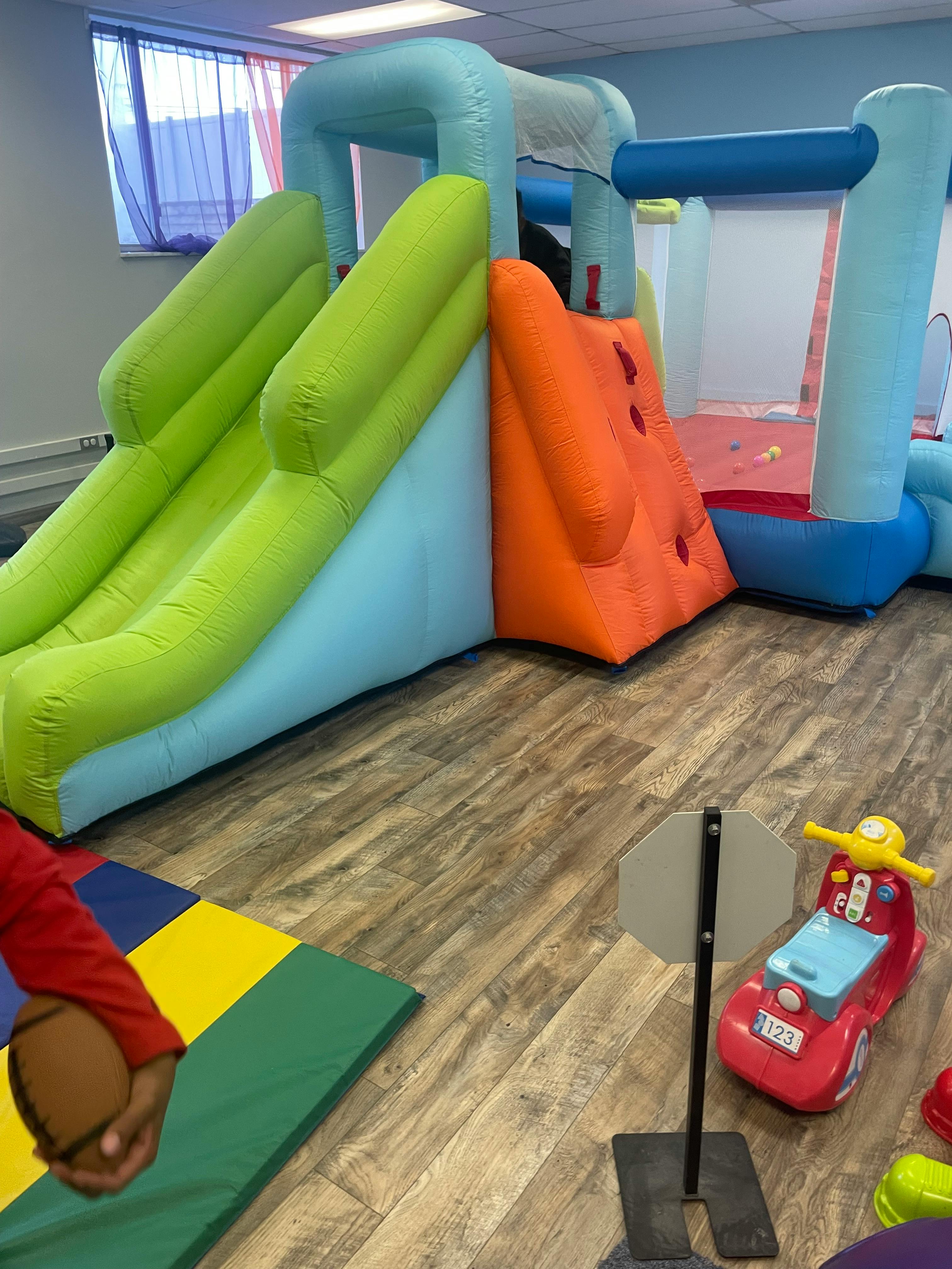 Inflatable bounce house with slides and climbing wall