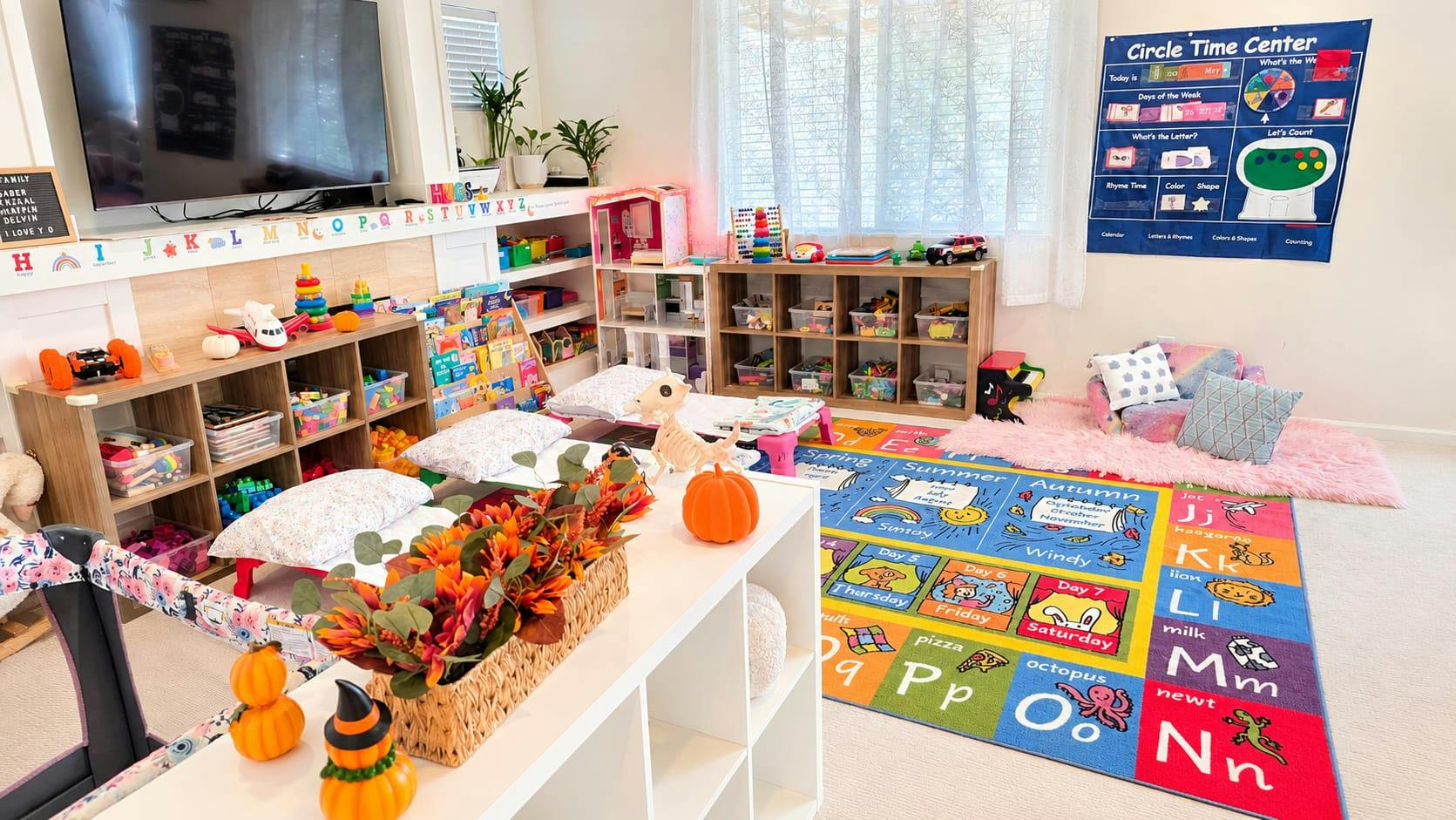 Playroom with educational area rug, toy shelves, and seasonal decorations