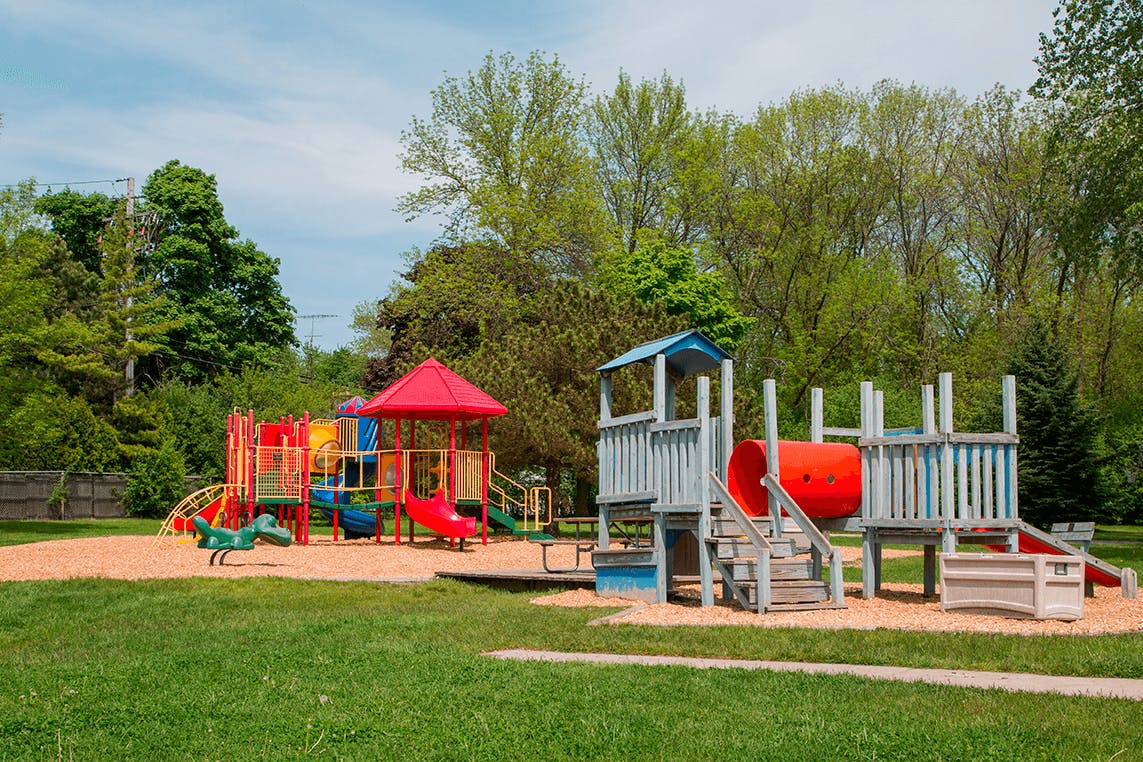 Playground with colorful slides and climbing structures on sand