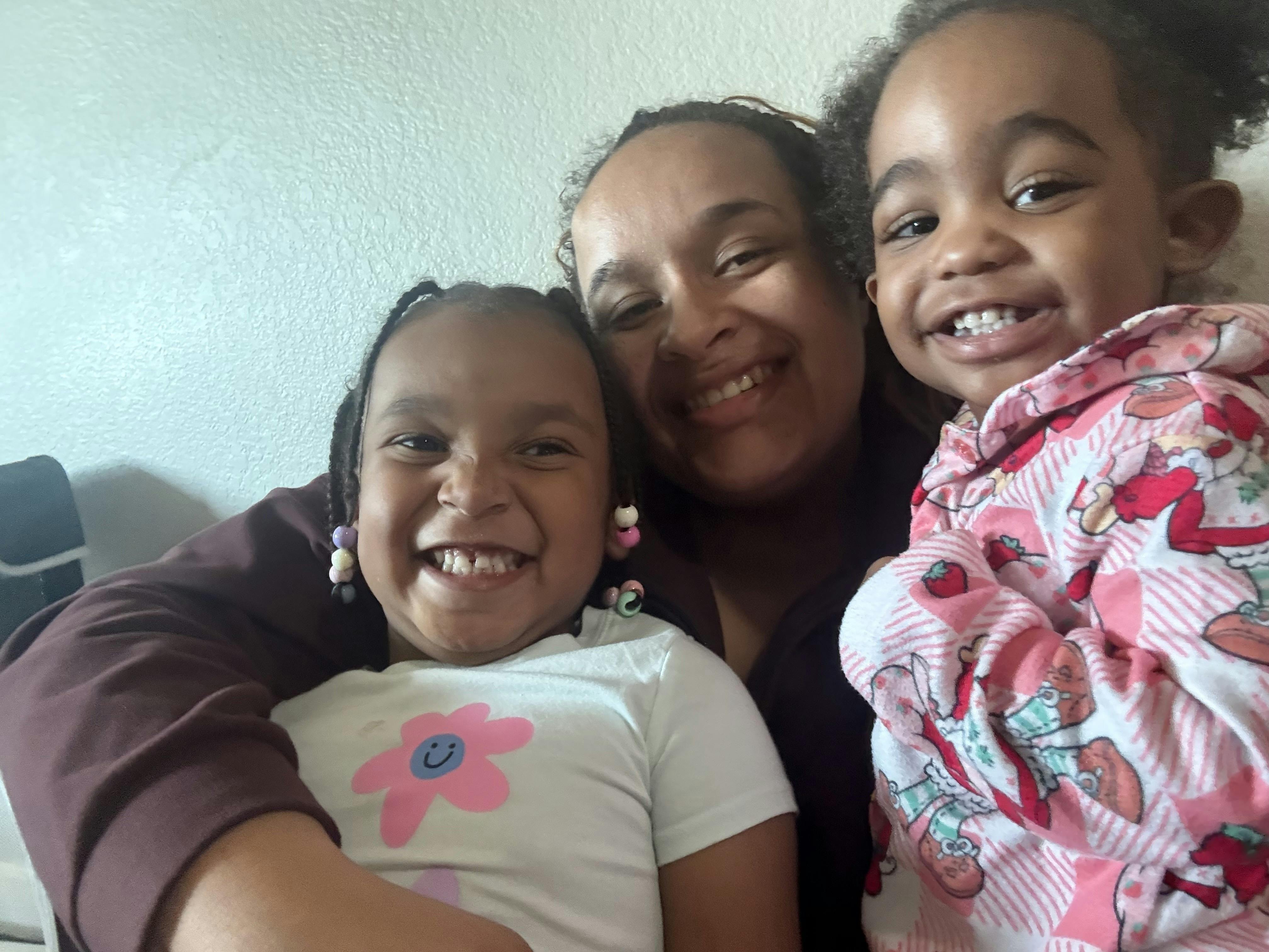 Person holding two children
