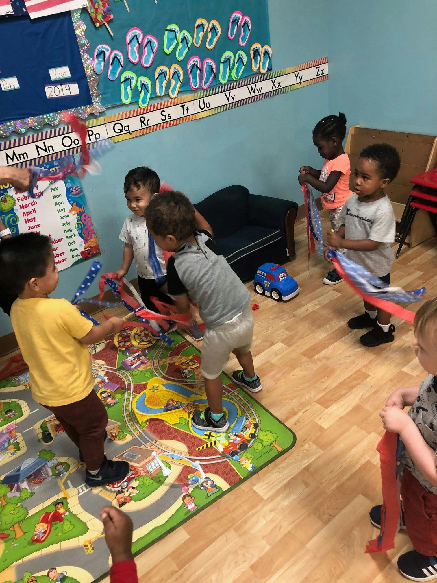 Children playing with ribbons in a classroom