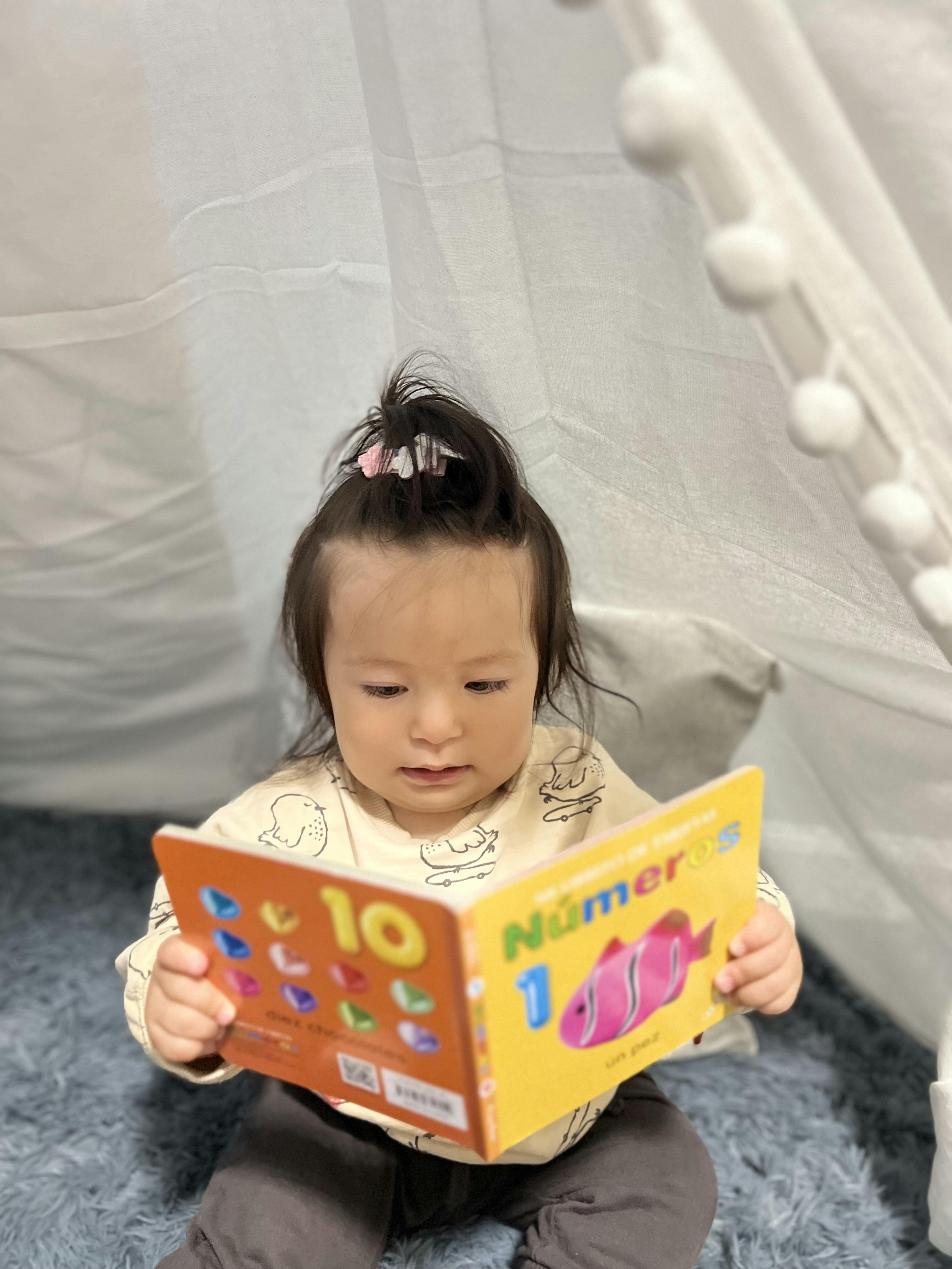 Child holding and looking at a colorful book